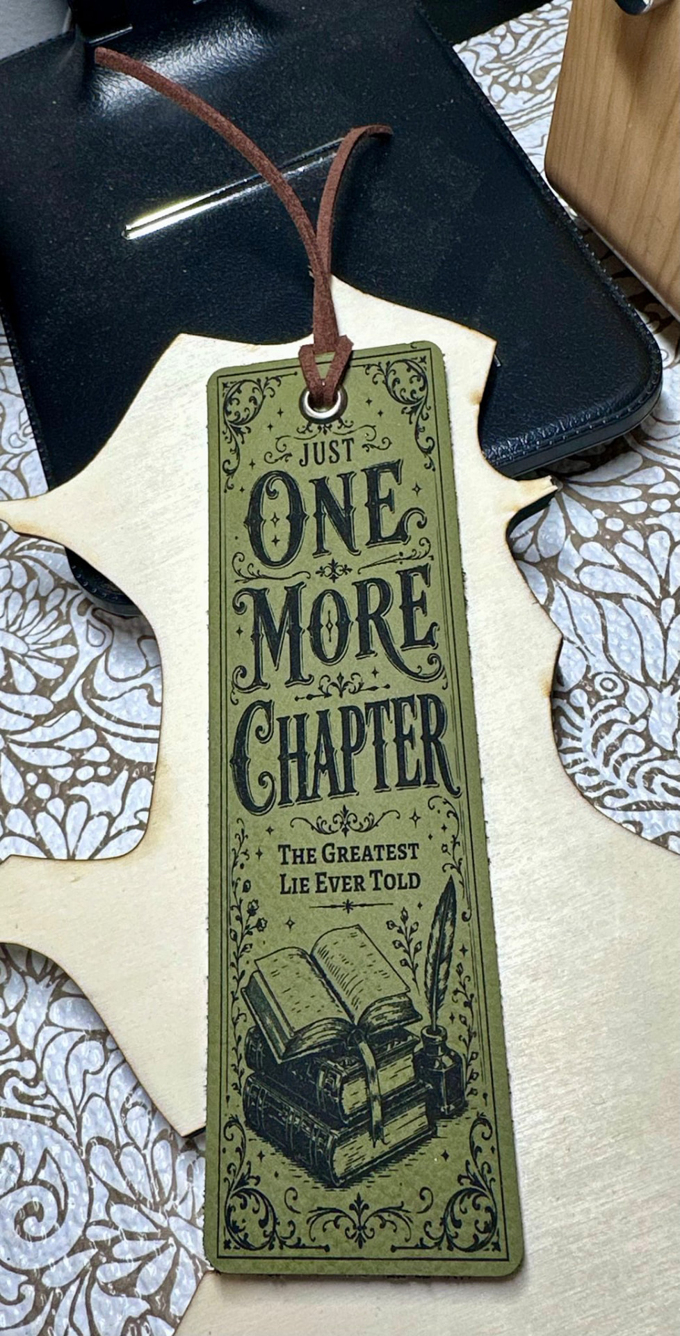 Olive leather bookmark engraved with Just One More Chapter