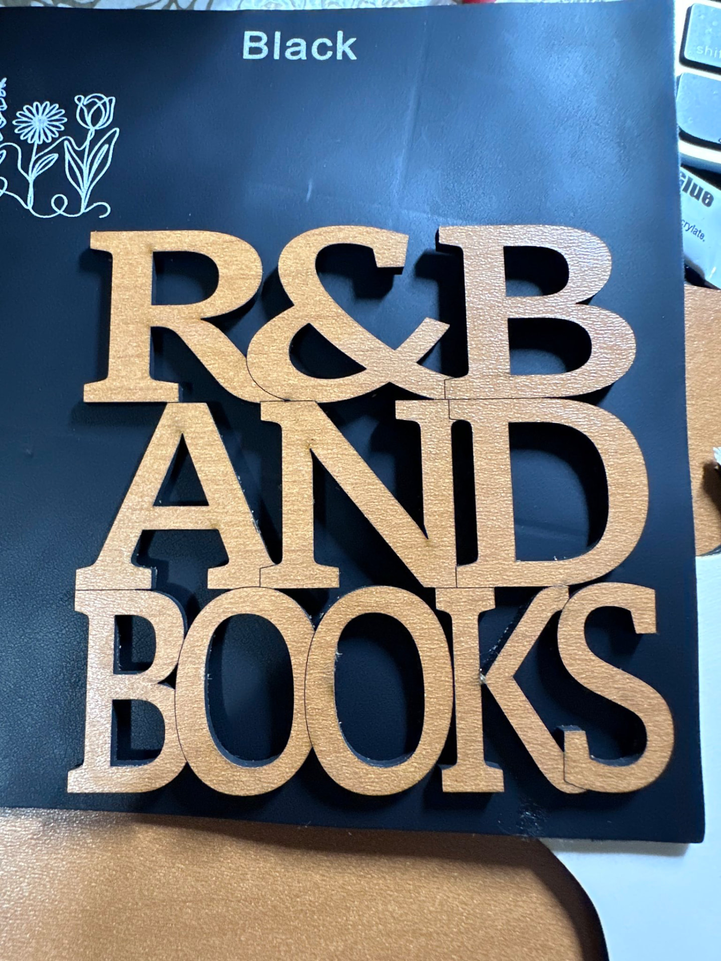 Cut wooden letters spelling R and B and Books