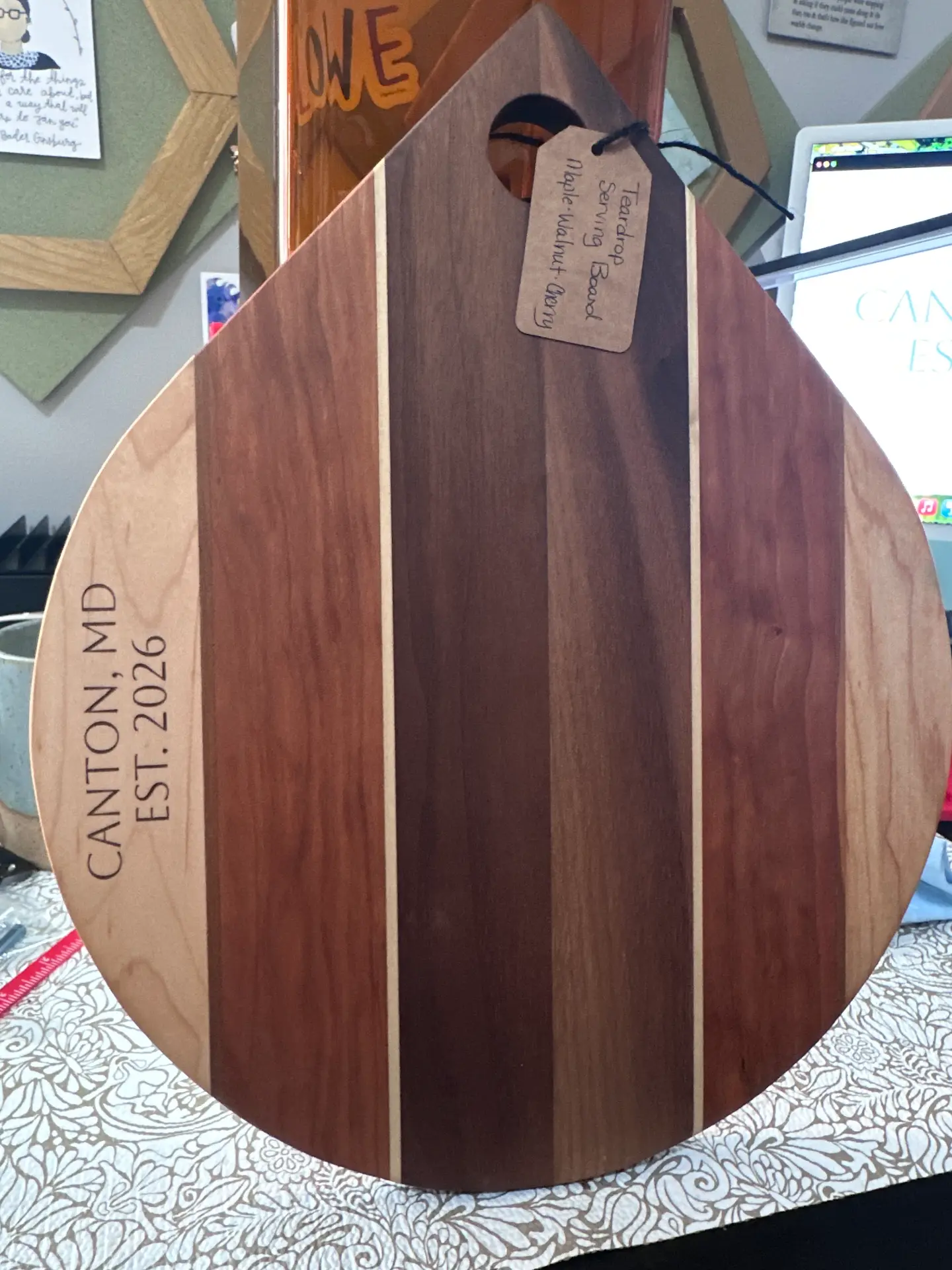 Teardrop-shaped maple, walnut, and cherry serving board engraved with Canton, MD Est. 2026