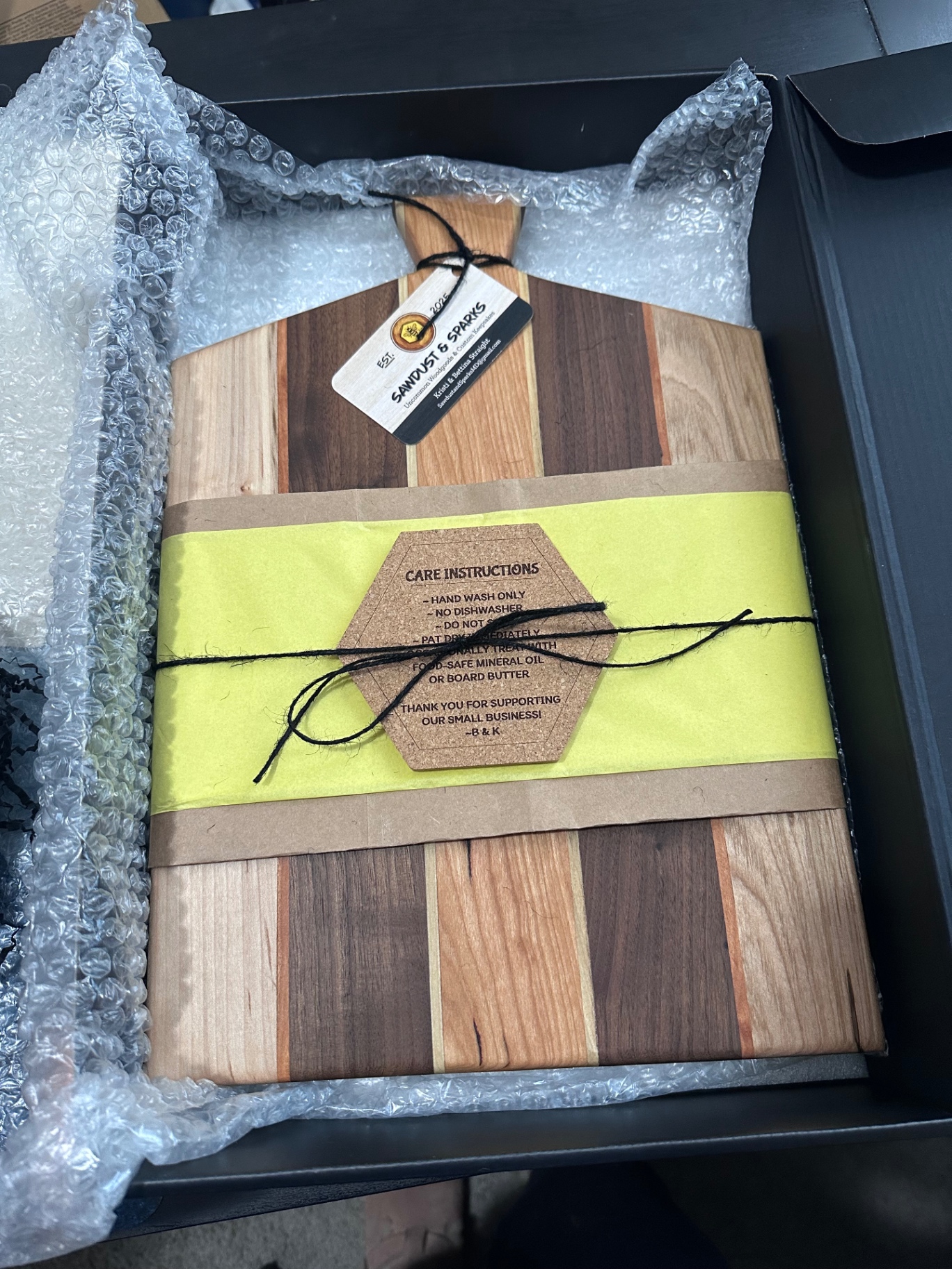Striped handcrafted cutting board packaged for delivery
