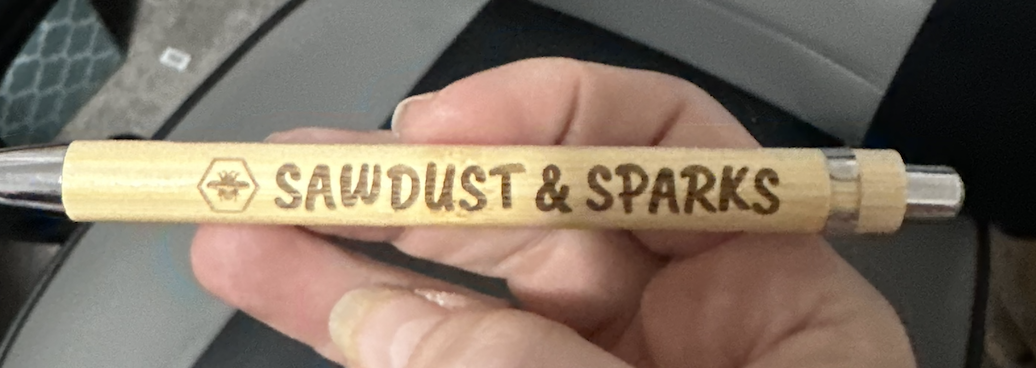 Bamboo pen engraved with the Sawdust & Sparks name and bee logo