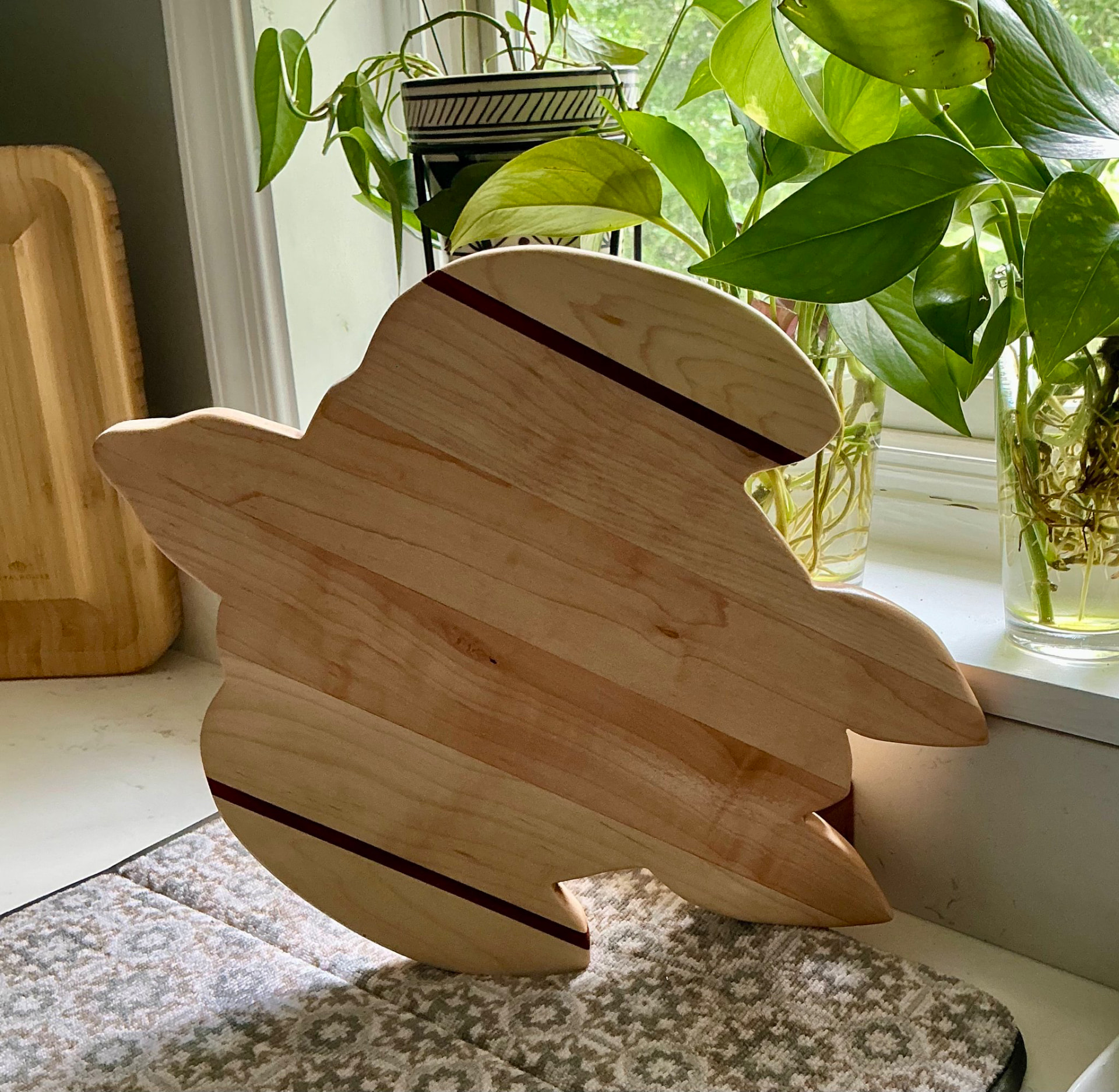 Maple sea turtle shaped cutting board with padauk stripe accents