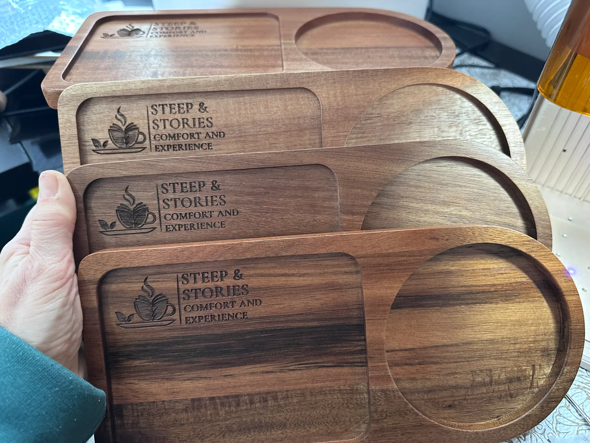 Walnut cafe serving trays engraved with the Steep & Stories logo