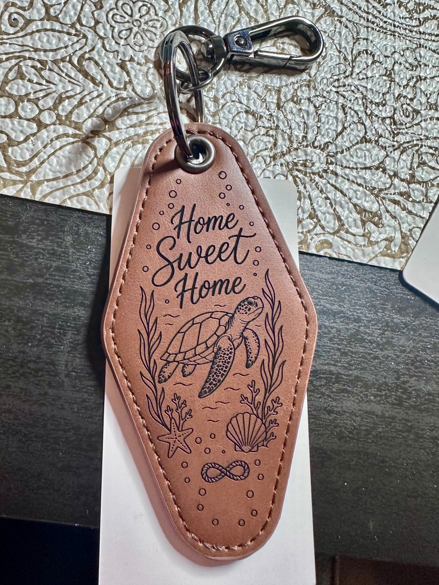 Leather motel-style keychain engraved with Home Sweet Home and a sea turtle