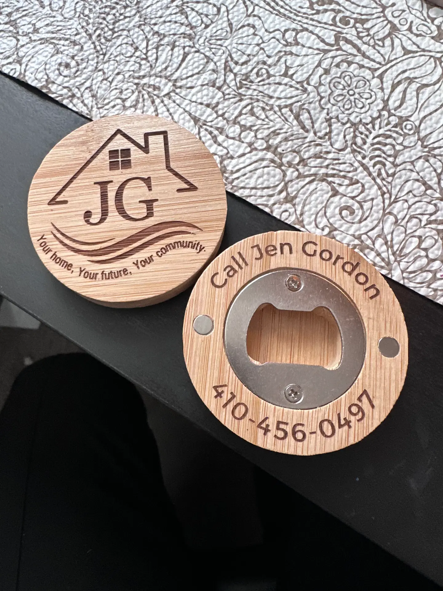 Bamboo magnetic bottle opener engraved with a realtor logo and phone number