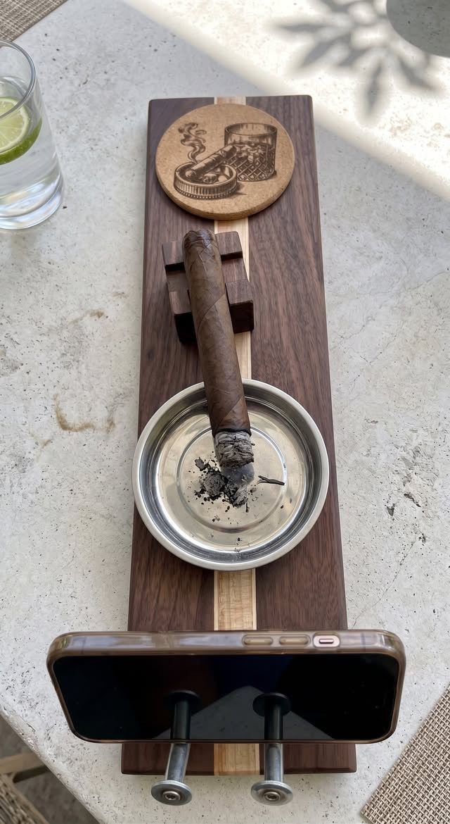Sip & Cigar Board Large with walnut cigar rest, cigar in stainless ashtray, engraved cork coaster, and maple cell phone holder